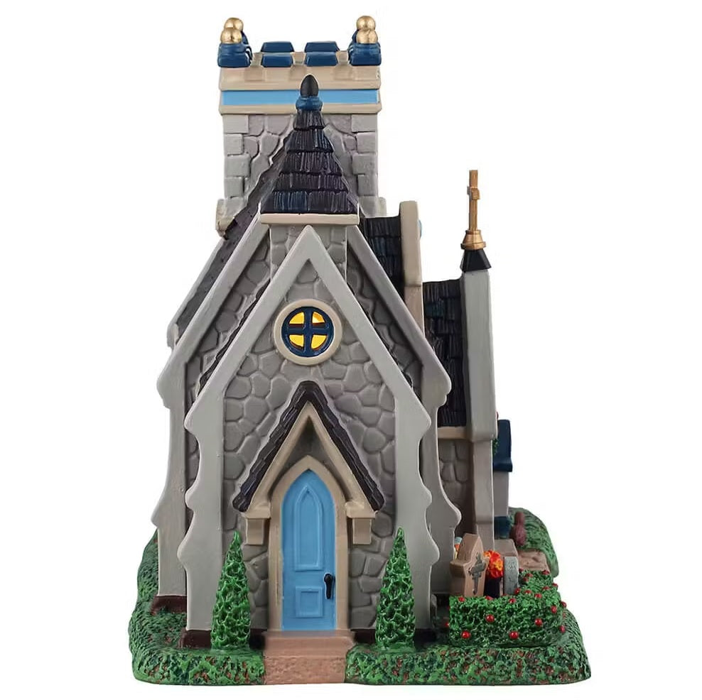 This is the side of the building. There's a skinny, blue side door and a circular window with light shining through.