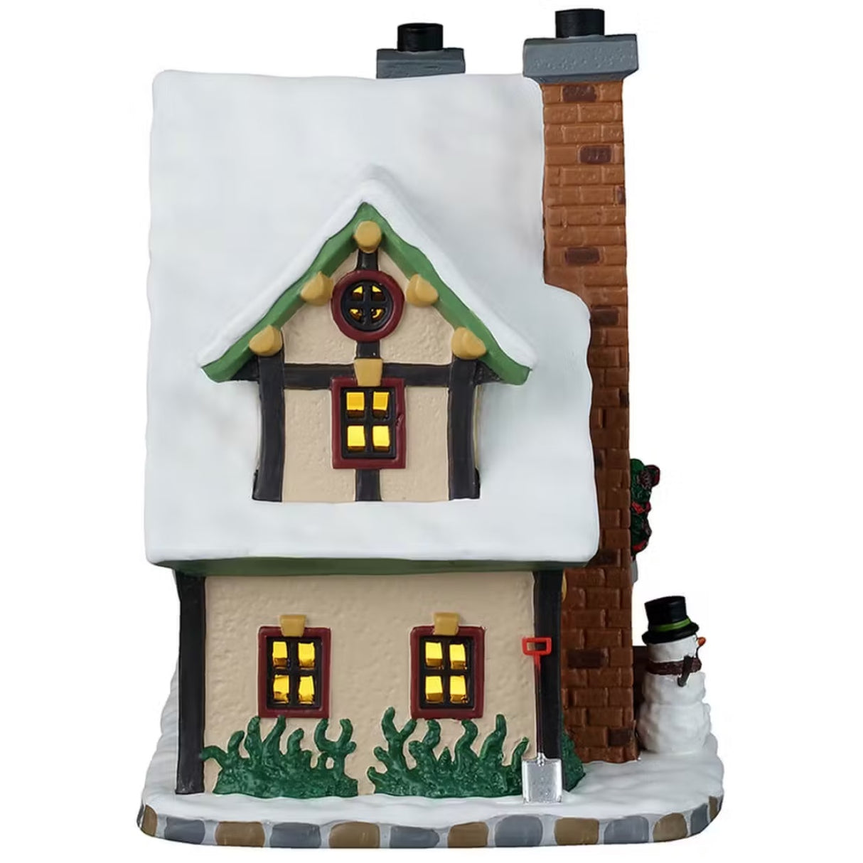 This is the side of the building. There are four windows with light shining through. There's grass peeking out from the snow and a silver shovel leaning up against the building.