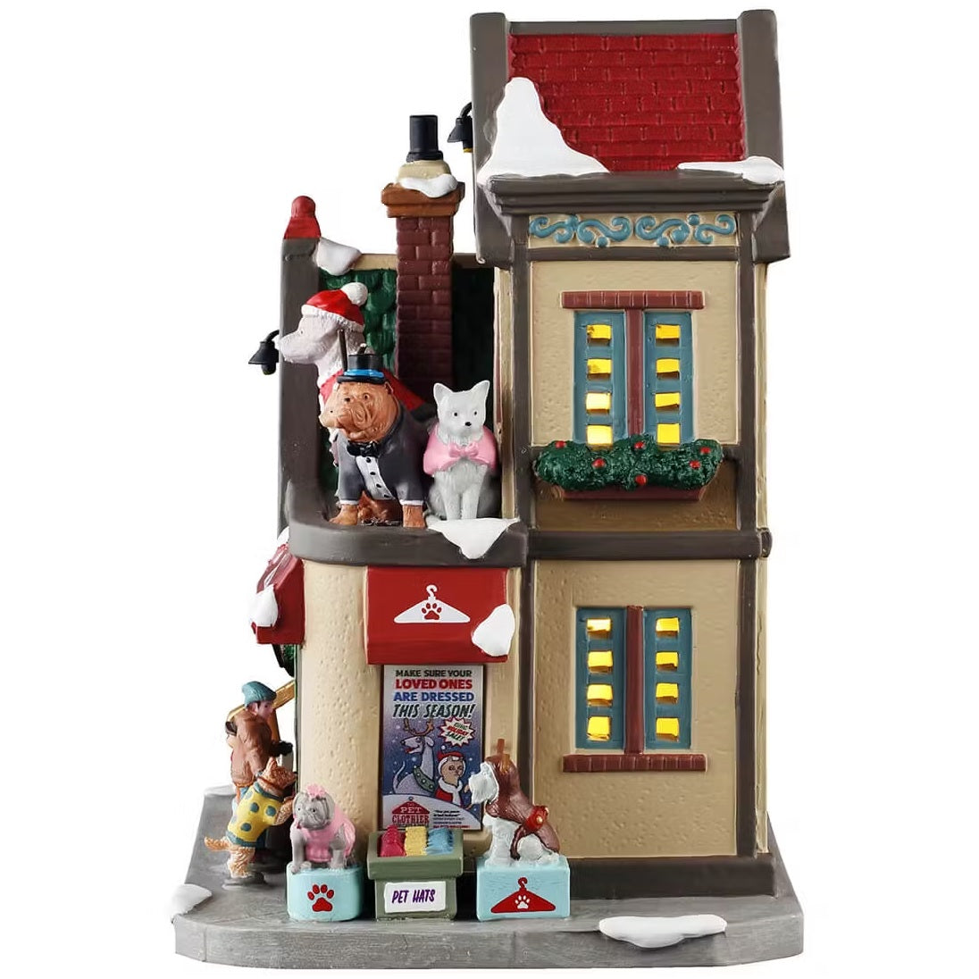 This is the side of this building. There's snow on the roof and on the sidewalk. On the sidewalk, there's a crate full of pet hats.