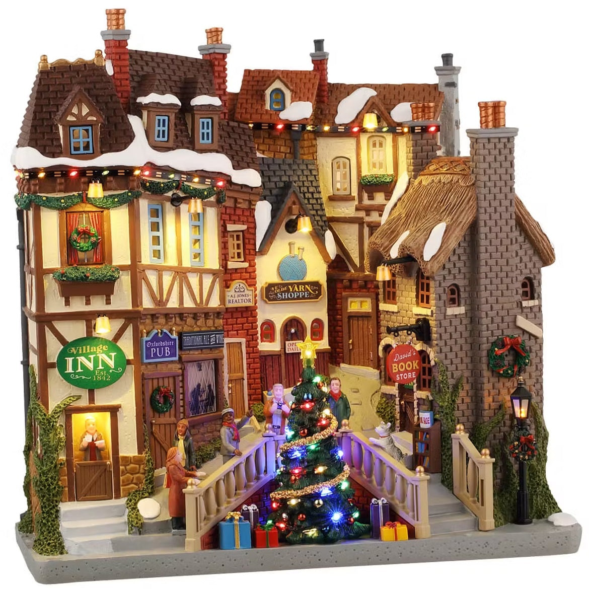 This is a large Lemax building facade made up of a bunch of different shops. There's the Village Inn, the Oxfordshire Pub, the Traditional Ale and White store, AJ Jones Realty, The Olde Yarn Shoppe and David's Book Store.