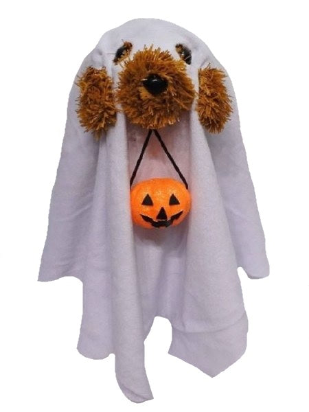 This tabletop decoration is a brown tinsel dog with black eyes and a black nose. He's wearing a soft, white sheet with eyeholes and a hole cut for his snout - so he looks like a ghost! He's holding a pail in his mouth that's shaped like a jack-o-lantern.