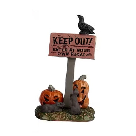 This is the sign that reads "KEEP OUT! ENTER AT YOUR OWN RISK!" There's a black crow on the top of the sign and two jack-o-lanterns at the base. There are also two rats sitting at the base of the sign.