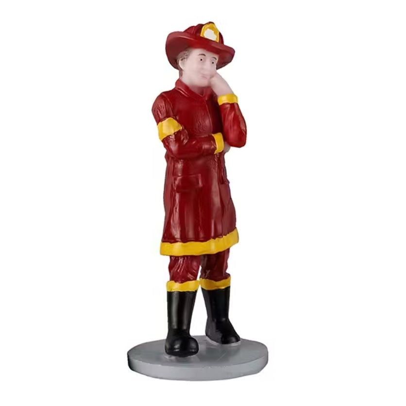 One of the kids is dressed as a firefighter, in a red and yellow uniform with black boots and a red hat.