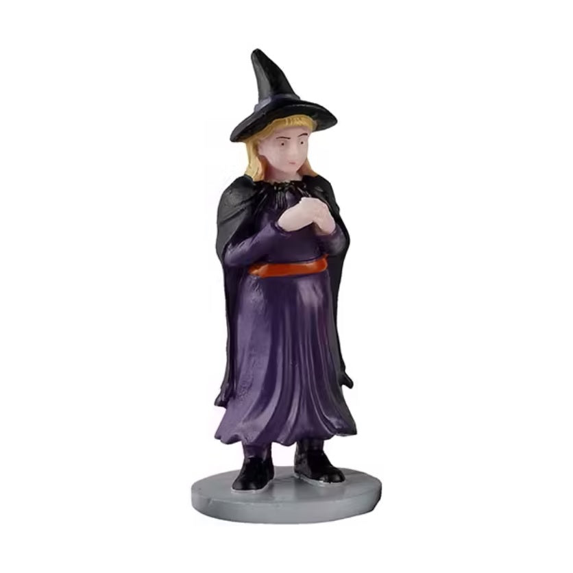 One of the kids is dressed as a witch in a purple dress with a black cape and a black pointy hat.