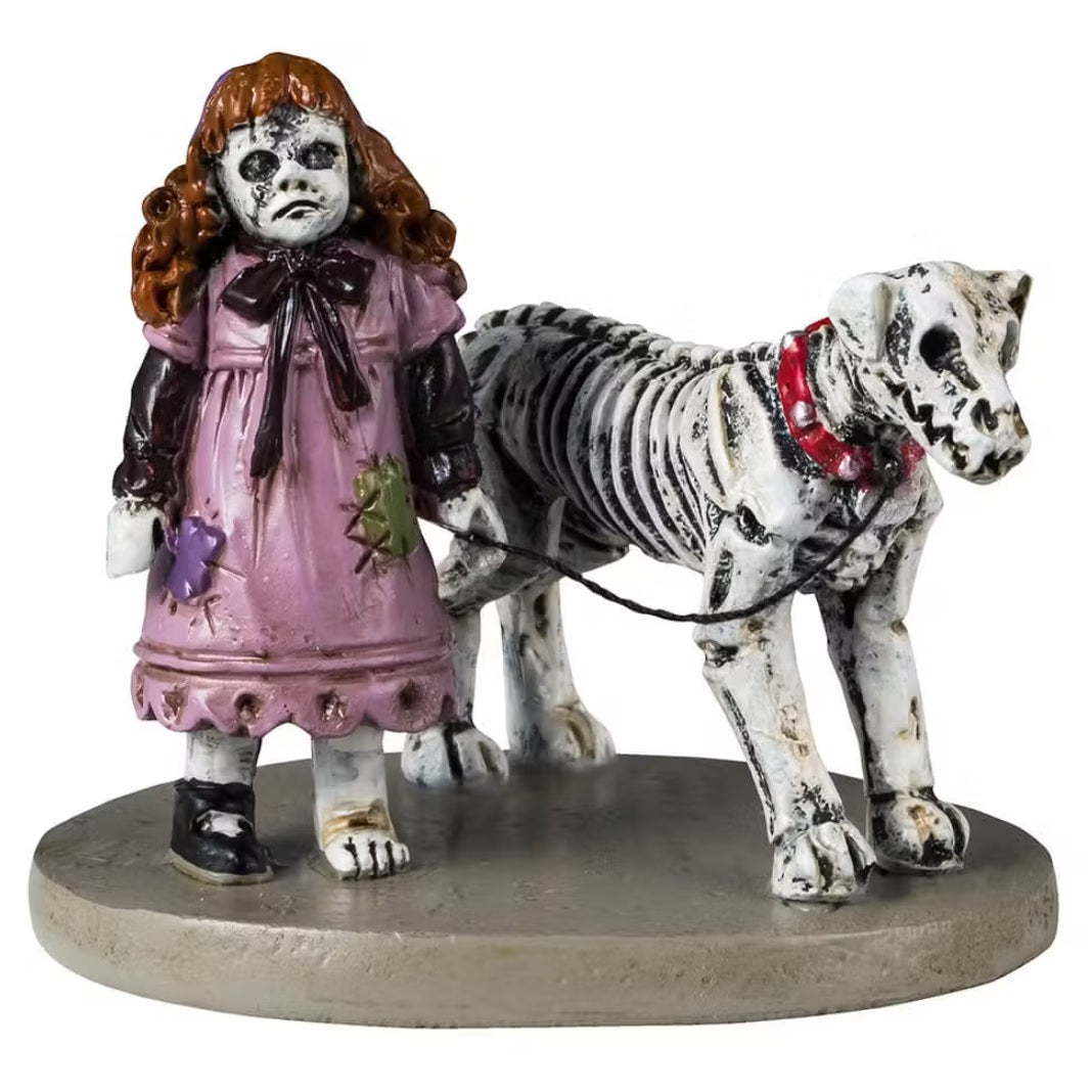 This is a Lemax Spooky Town figurine that shows a young zombie girl wearing a pink dress with patches sewn into it. She has one shoe on. She has a skeletal dog on a leash.