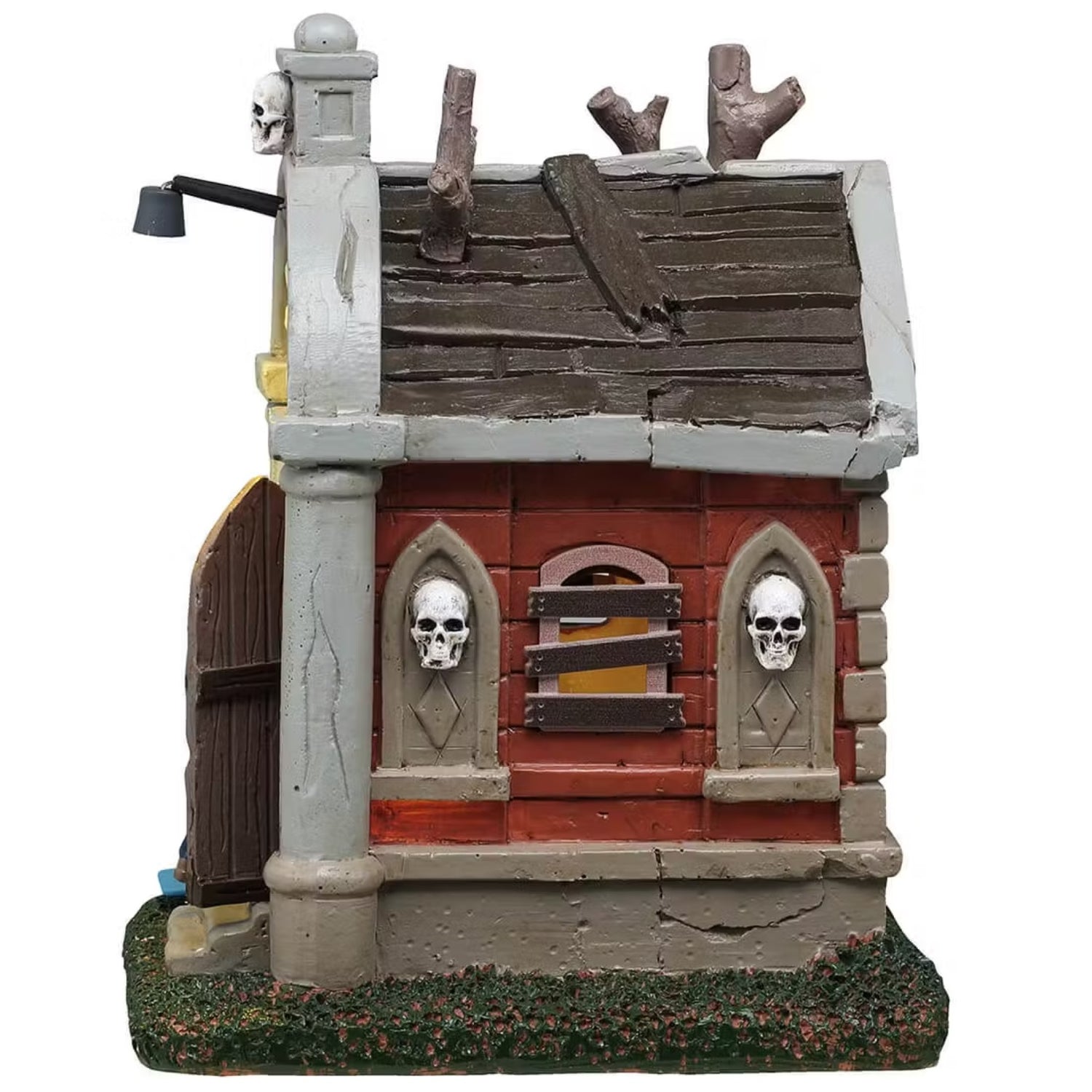 This is the side of this Lemax building showing off one of the boarded up windows and the two skulls that are on the side for decoration.