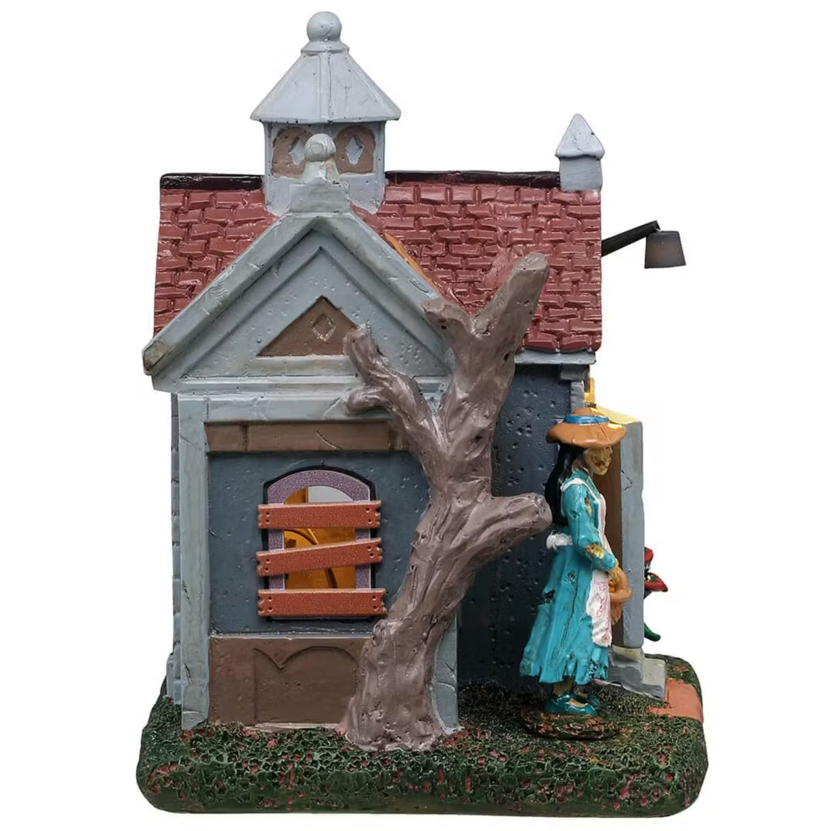 This is a different angle of this Lemax Spooky Town building that's designed to look like a rundown garden shed. There are holes patched up with slats of wood, windows boarded up and plants with teeth growing near the front door. A woman wearing a blue dress and a white apron is standing near the front door holding a basket.