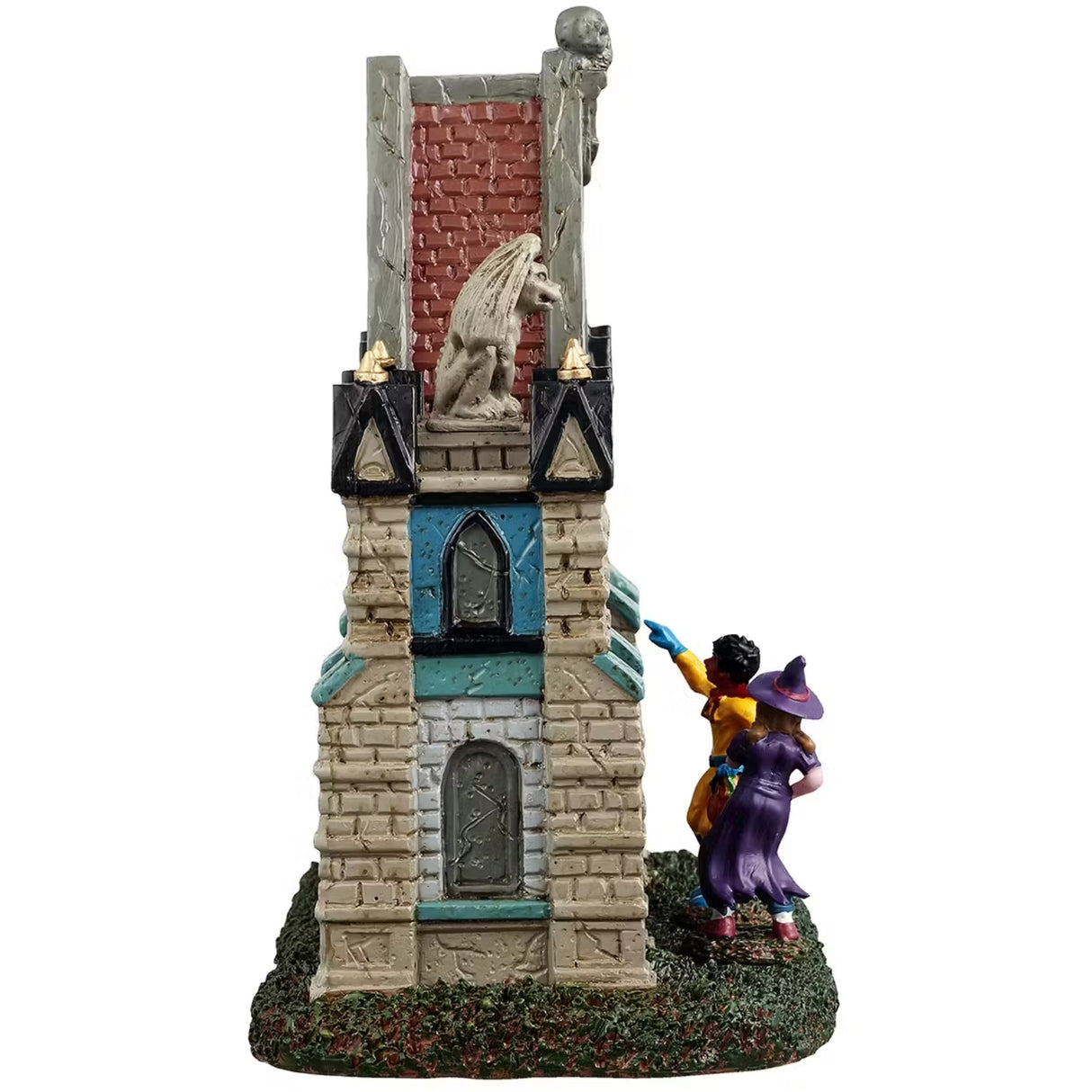 This is a different angle of the Lemax Spooky Town table accent designed to look like a Gothic gate. There are gargoyles and skeletons and pointed columns. There are also two trick or treaters trying to get in. One is dressed like a purple witch and the other is dressed like a superhero with a red cape.