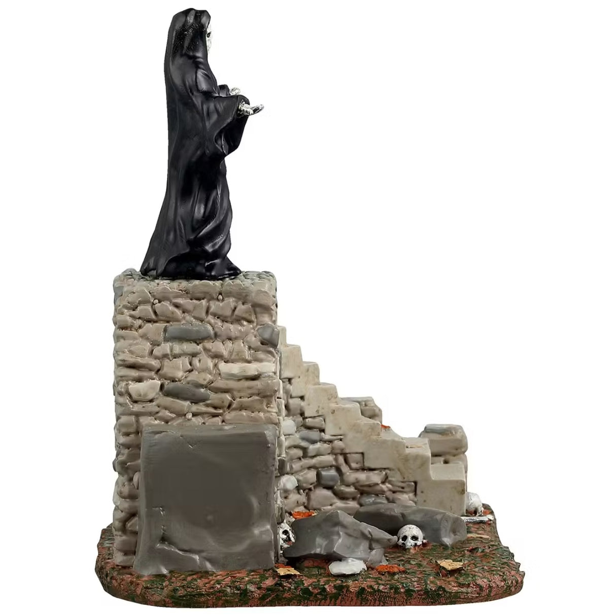 This is a different angle of the Lemax Spooky Town table accent that's designed to look like the Grim Reaper standing on top of a set of stone steps. There's an archway at the base of the stairs that has a bunch of skeletons and skulls inside.