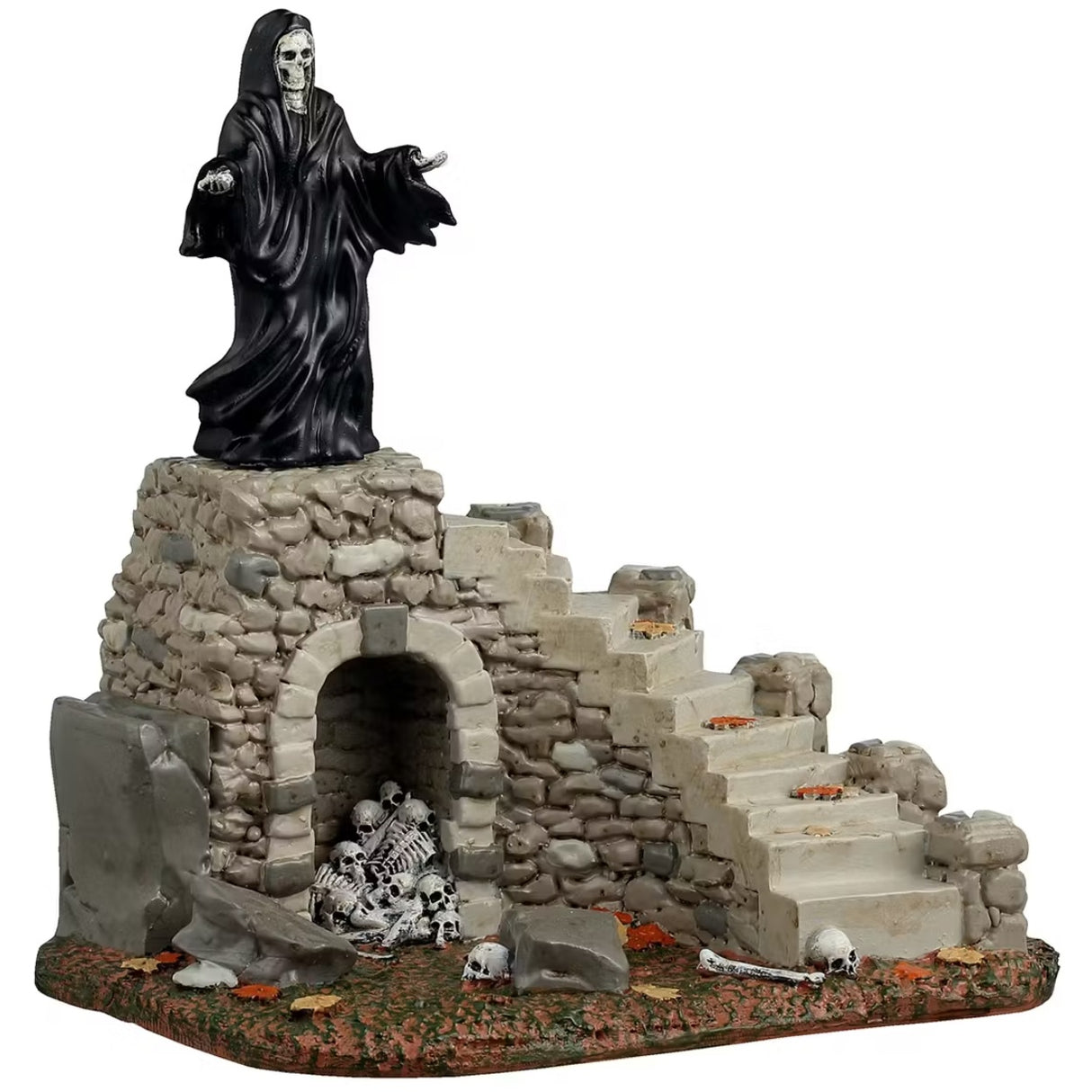 This is a Lemax Spooky Town table accent designed to look like the Grim Reaper standing on top of a set of stone steps. There's an archway at the base of the stairs that has a bunch of skeletons and skulls inside.