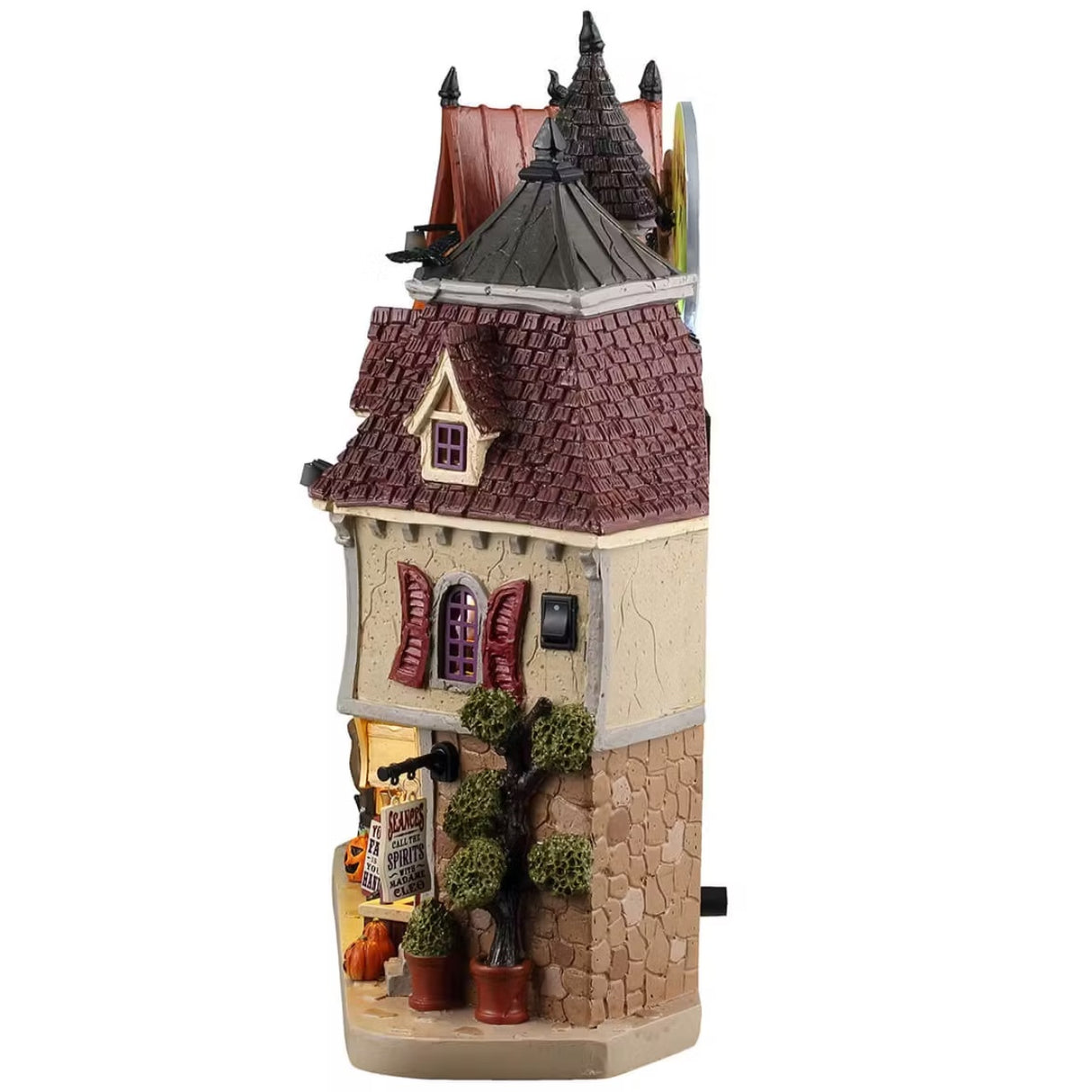 This is the side of the mansion where you can see a few potted trees and jack-o-lanterns on the sidewalk.