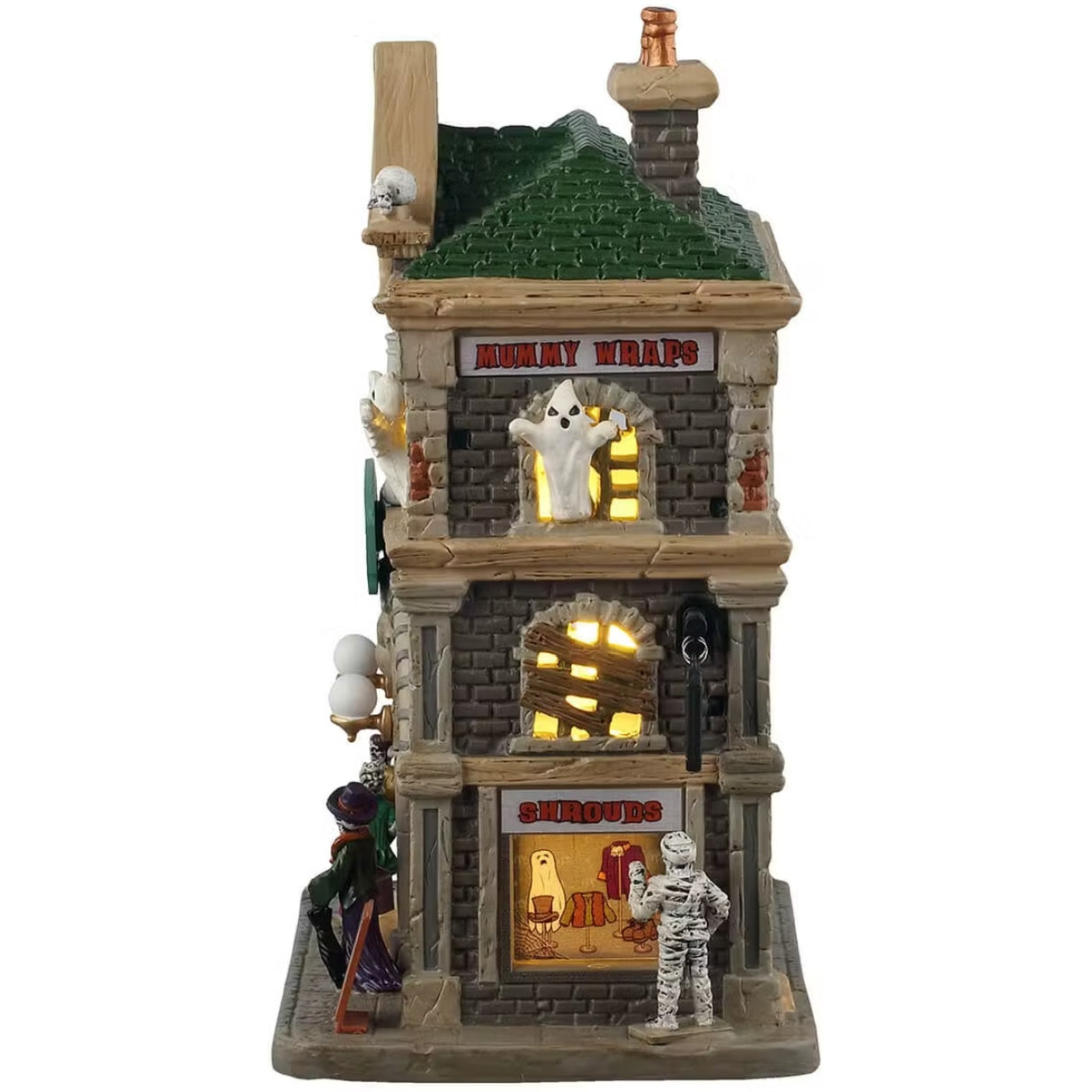This is the side of the building. Near the roof, there's a sign that reads "MUMMY WRAPS." There's a ghost coming out of the top window, the second window is boarded up and the third window is showcasing a ghost sheet, a hat, some jackets and shoes. There's a mummy looking into the window and pointing at something.