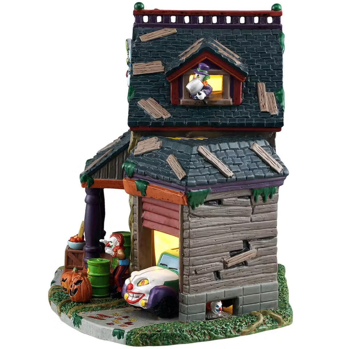 This is the side of the house. There's a clown holding a giant hammer hanging out of the window in the attic. At the base of the garage, there's a small clown holding a horn.