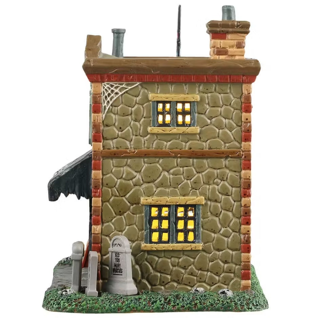 This is the side of the building. You can see light through the windows and tombstones on the sidewalk.