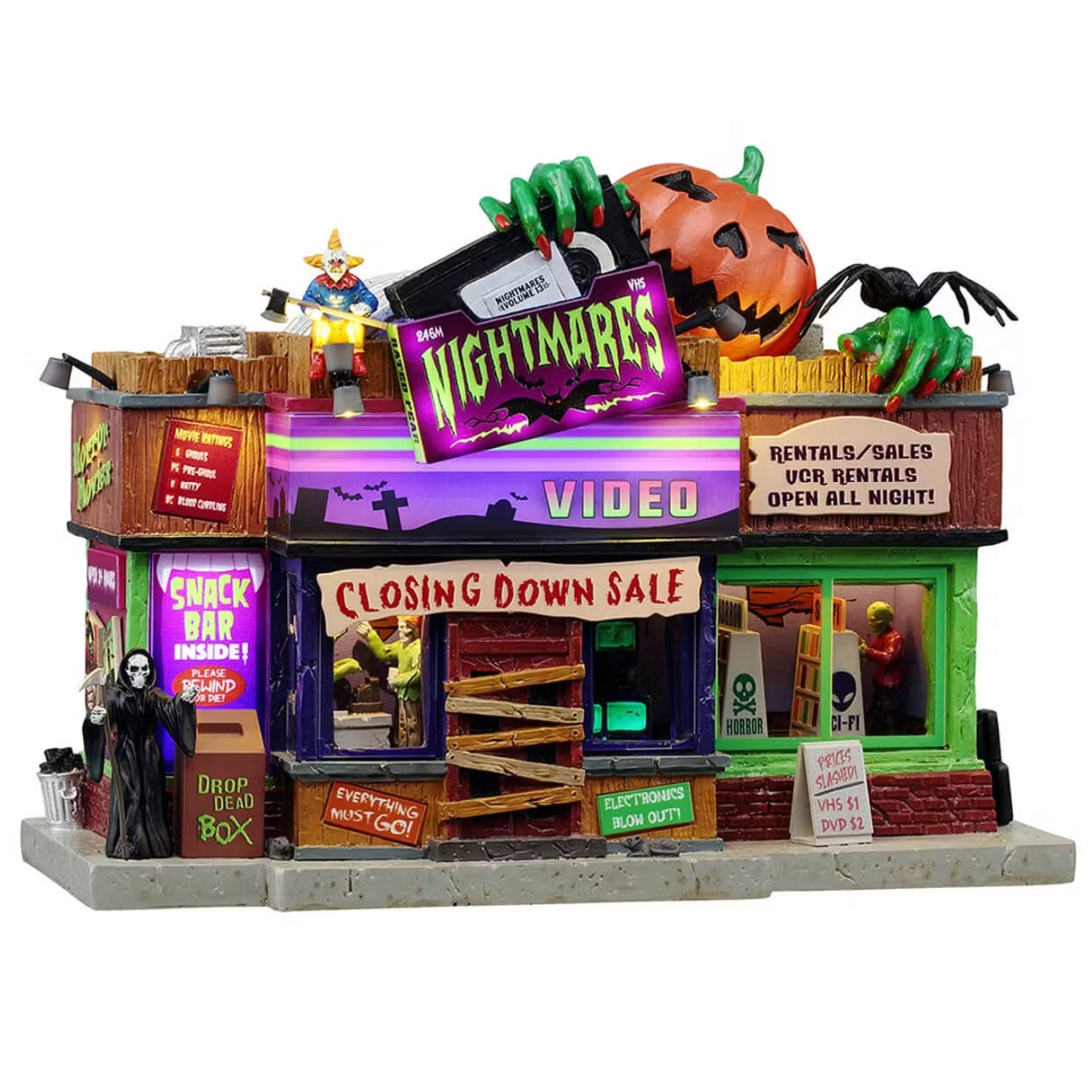 This is a Lemax Spooky Town building designed to look like a slightly rundown video rental store called Nightmares Video. There are signs that read "Closing Down Sale," "Everything Must Go," "Electronics Blow Out," "Prices Slashed! VHS = $1, DVD = $2" and "Snack Bar Inside! Please rewind or die!"
