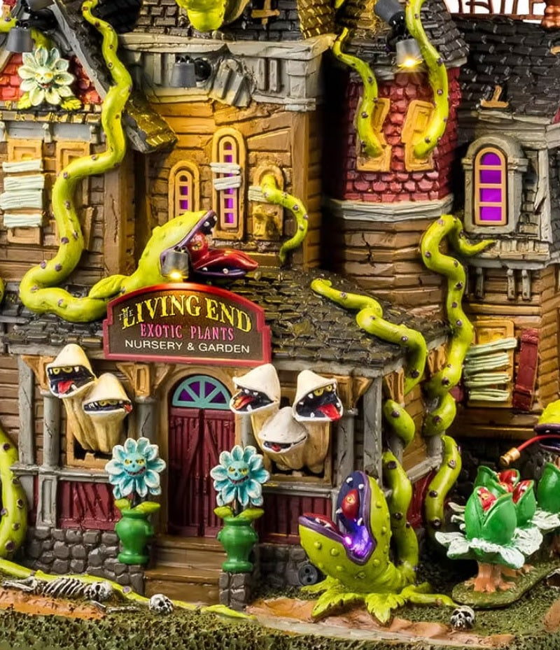 This is an up close view of this Lemax Spooky Town lighted building designed to look like a dilapidated mansion that's been overtaken by man-eating plants. The sign above the door reads "The Living End Exotic Plants Nursery and Garden."