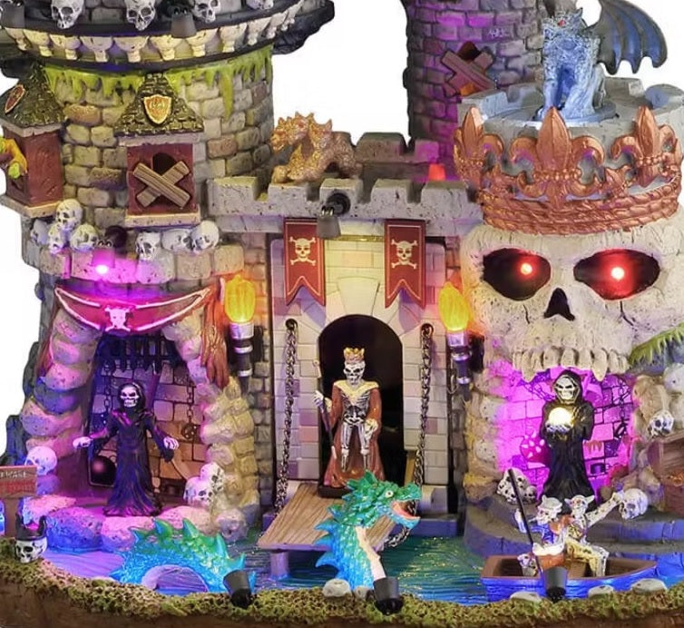 This is an up close look at the building. You can see a three-headed dragon above the main entrance. There's a monster standing on the drawbridge over the water.