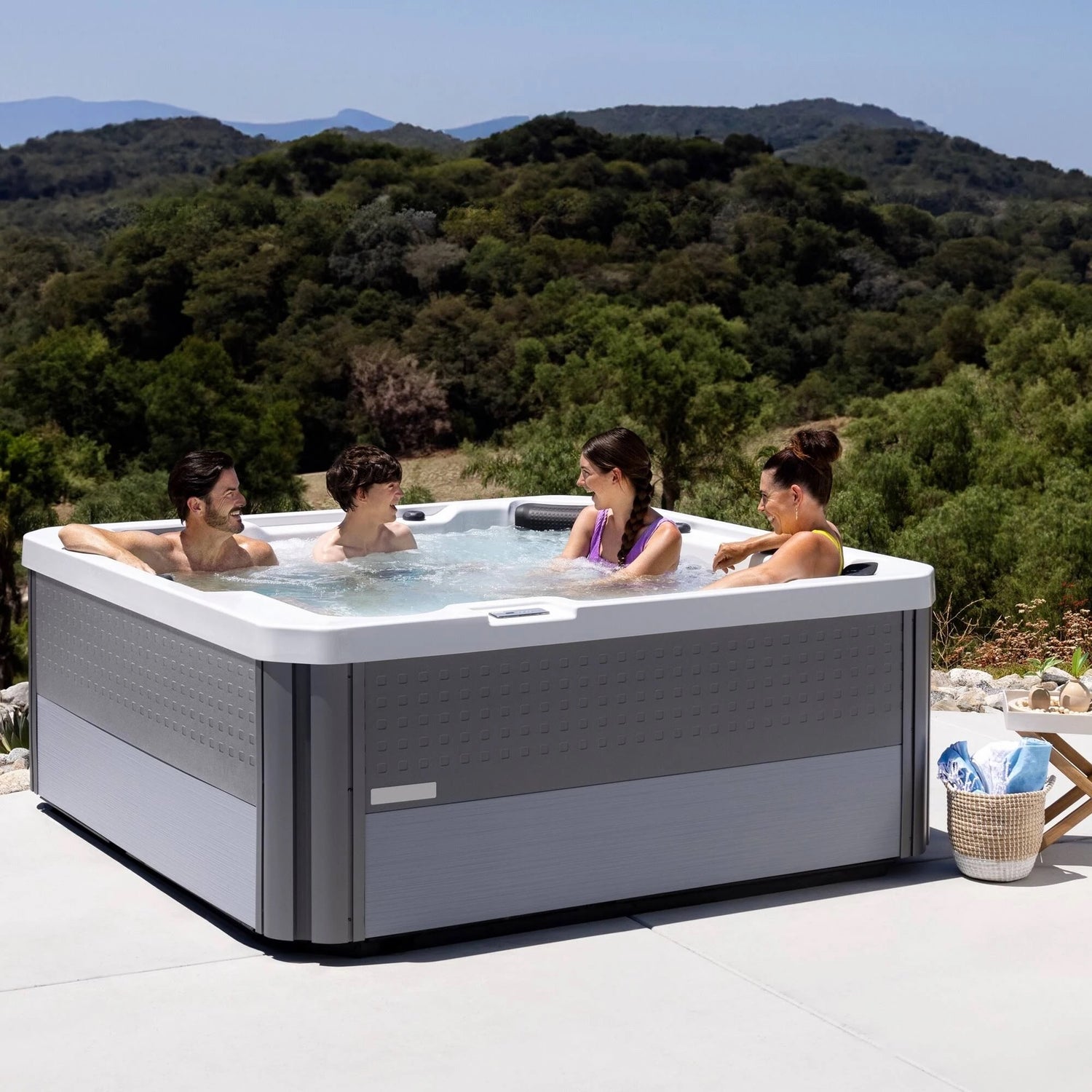 This is a lifestyle image of four people inside the hot tub in an exotic location.