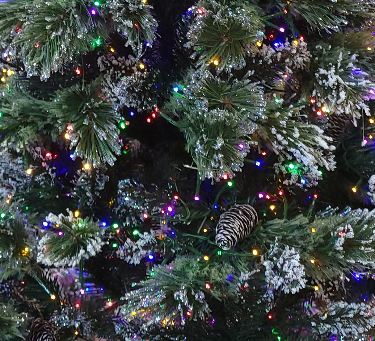 This is an up close view of the flocked branches, the pine cones and the multi-colored Galaxy LED lights.