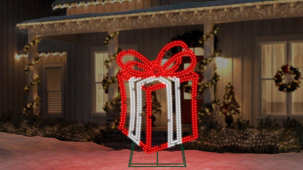 This moving image shows the Red and Pure White LED present twinkling on the snowy front lawn of a house decorated for Christmas.