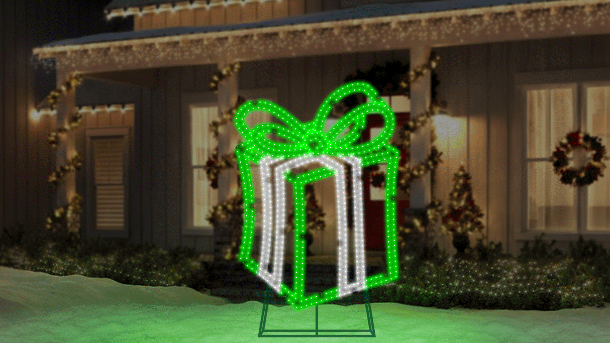 This moving image shows the Green and Pure White LED present twinkling on the snowy front lawn of a house decorated for Christmas.