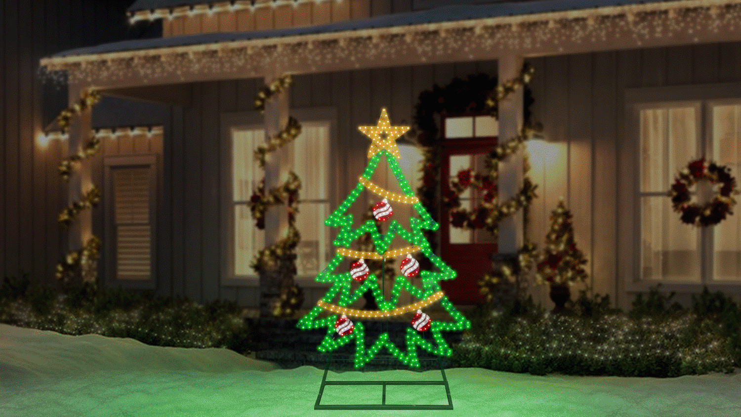 This animated image shows the twinkling tree decoration on a snowy yard in front of a house decorated for Christmas.