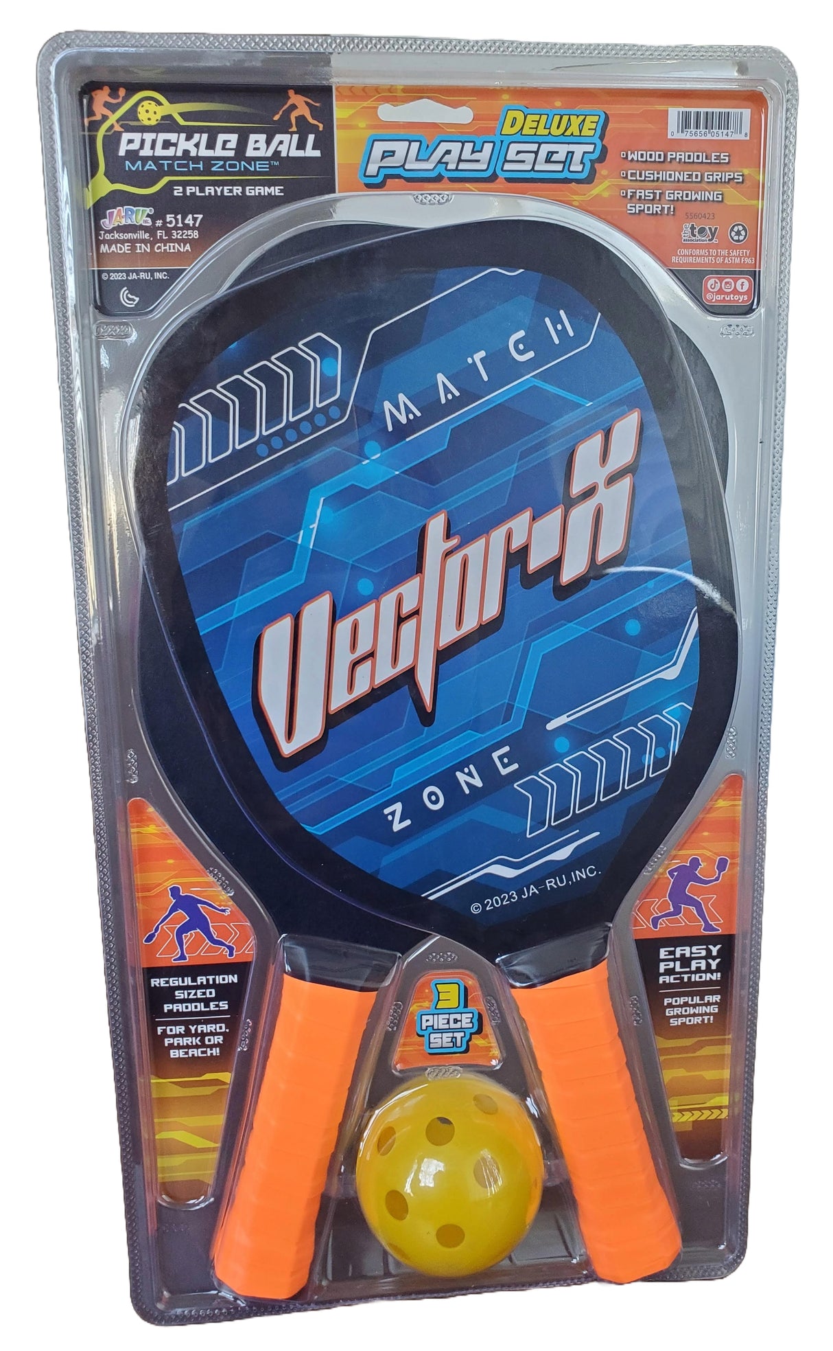 Pickleball deluxe play set. This image shows what the set looks like in its packaging. Set includes two blue wooden paddles with orange cushioned handles. The ball that is included is yellow.