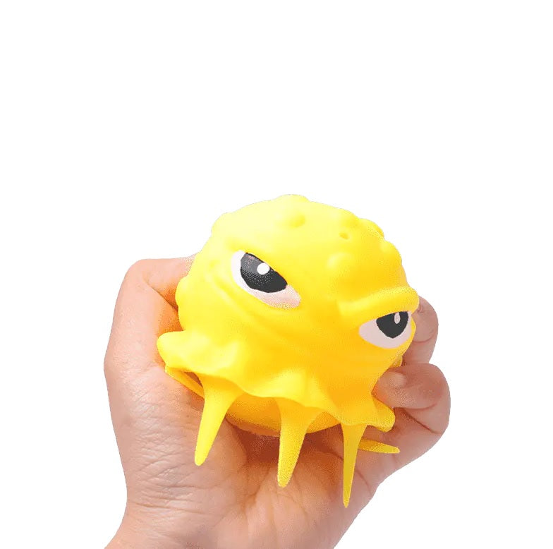 This image shows the yellow squid ball inside someone's hand.