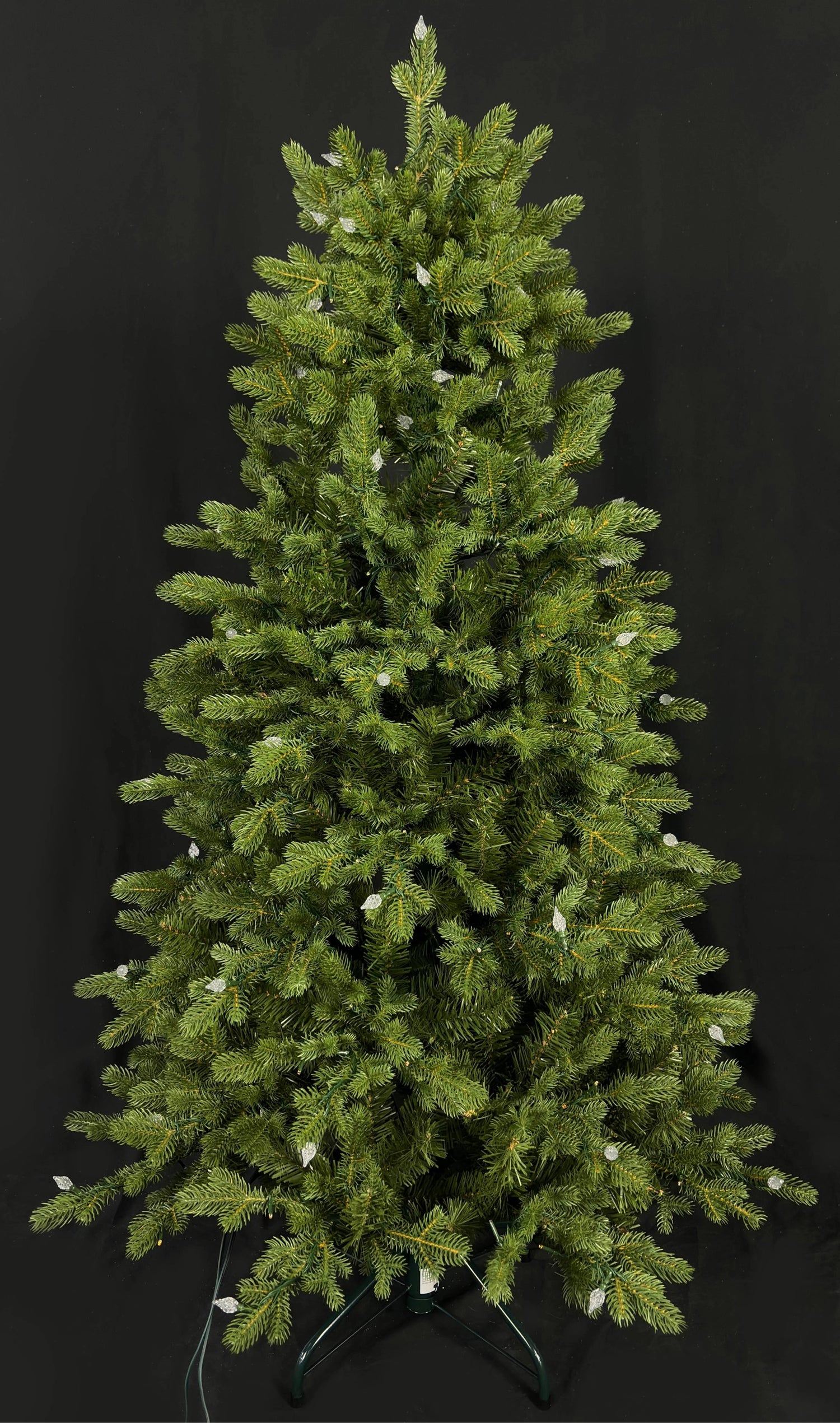 This image shows this specific artificial tree with the lights turned off. This tree is up against a black background.