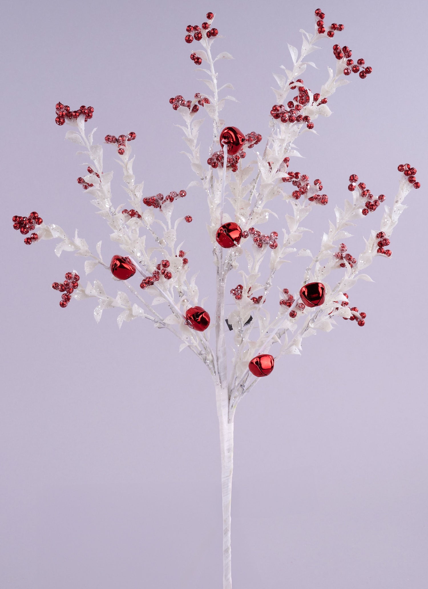 This image shows this pick spray up against a light purple background. The pick is a white stem with glittered white branches with small glitter leaves on them. Some of the branches are decorated with red jingle bells, in both small and large sizes.