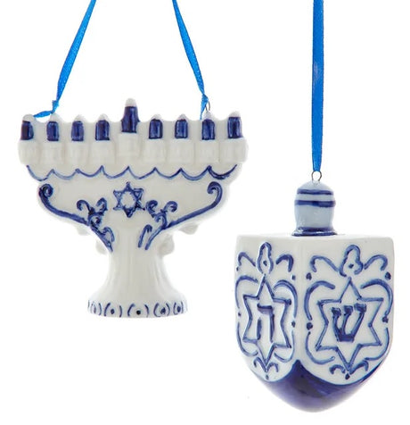 One ornament is shaped like a white menorah with blue candles. One ornament is shaped like a blue and white dreidel.