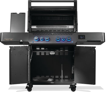 Black Napoleon grill. There is a built-in thermometer on the lid, there are two shelves outstretched, six buttons and a cabinet that opens up underneath. This is the view of everything open.