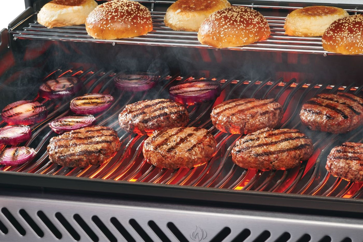This is a lifestyle image showing different foods being cooked on the grill.