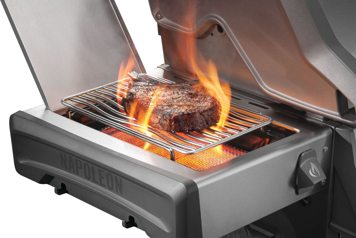 This is an up close view of the side burner in use. There's a steak cooking on it.