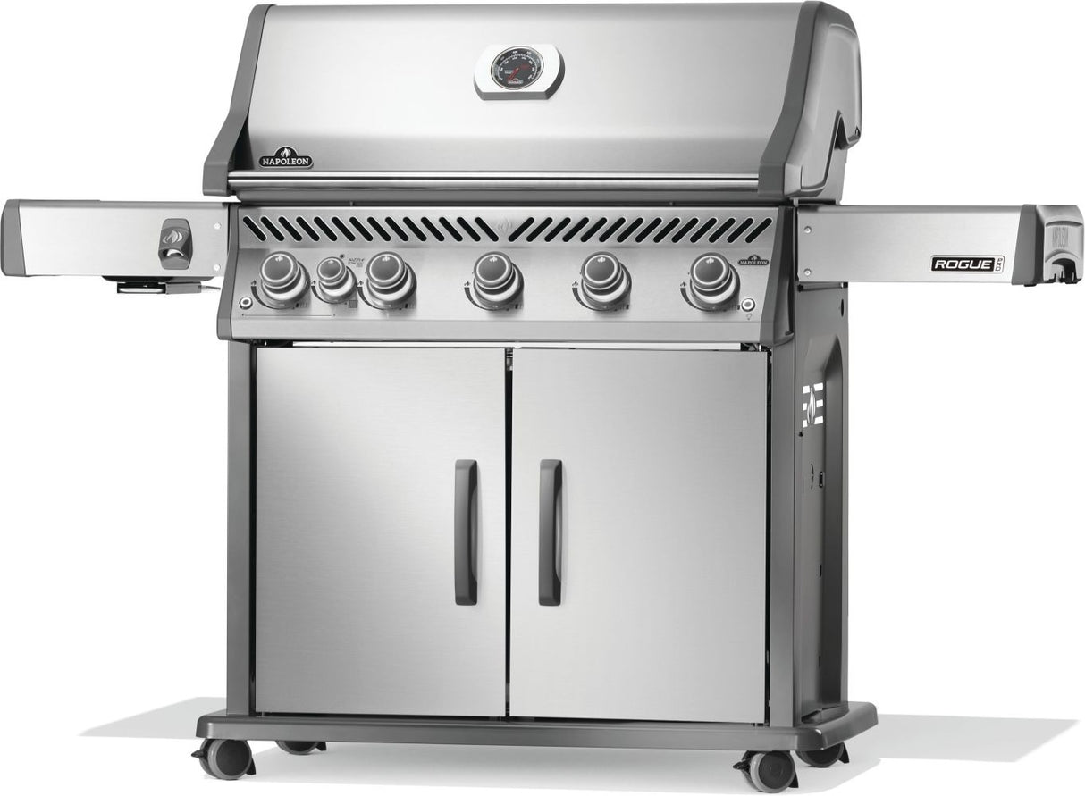 Silver and gray Napoleon grill. There is a built-in thermometer on the lid, there are two shelves outstretched, six buttons and a cabinet that opens up underneath. This is the right side view.