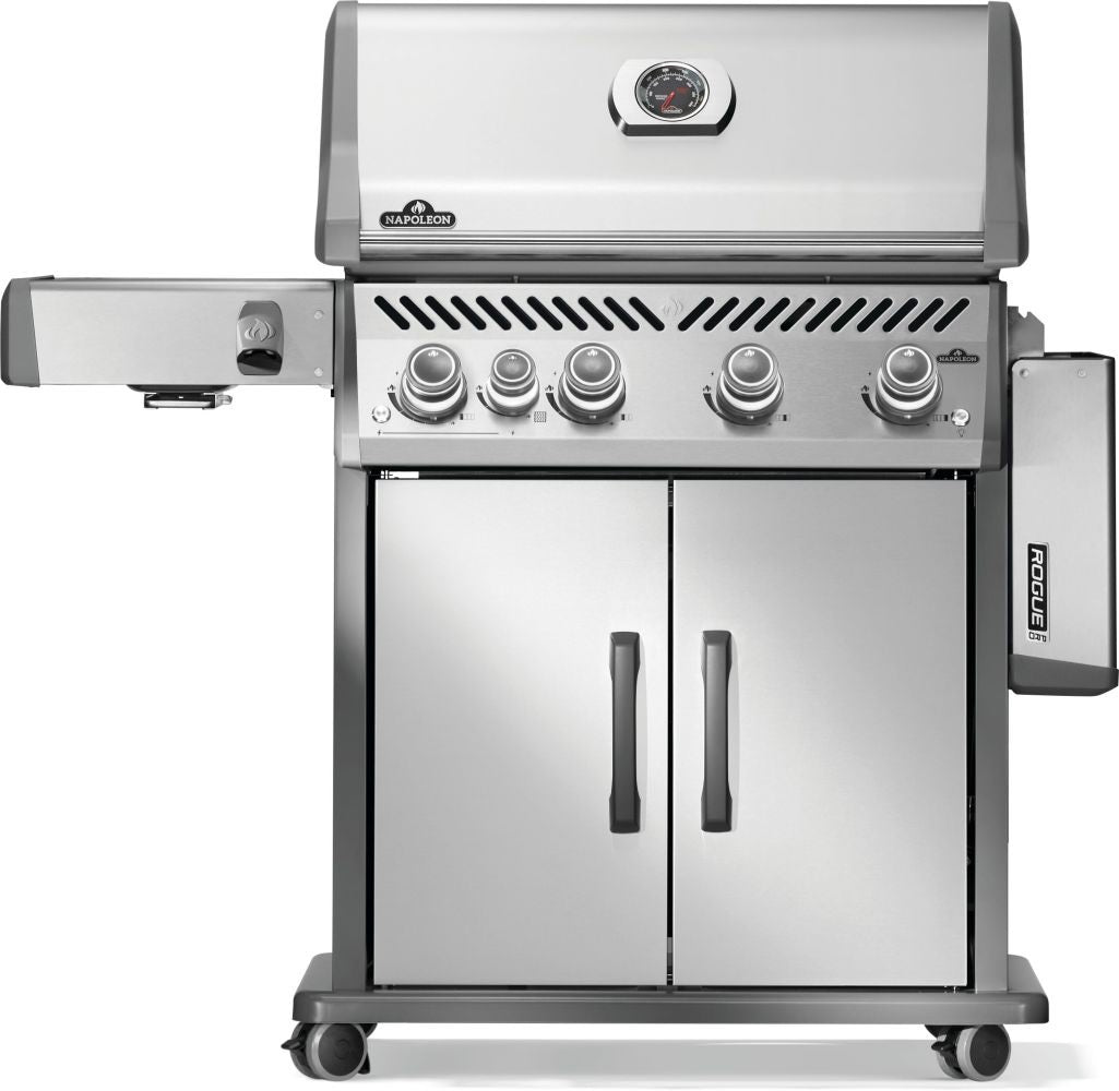 Silver and gray Napoleon grill. There is a built-in thermometer on the lid, there are two shelves outstretched, five buttons and a cabinet that opens up underneath. This is the front view with one shelf down.