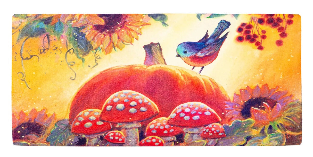 This welcome mat features a darling bird sitting on a pumpkin surround by mushrooms and sunflowers.