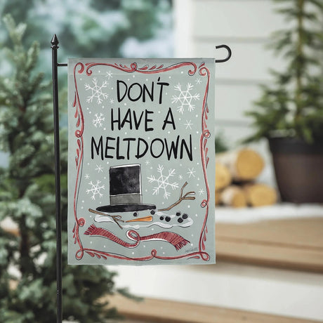 Gray/Teal colored flag with funny sayings on both sides. One reads "Dear Santa, can we negotiate?" and features three presents and pine needles and berries around the border. The other side reads "Don't have a meltdown" and features a melted snowman. There's a red swirling design along the border.