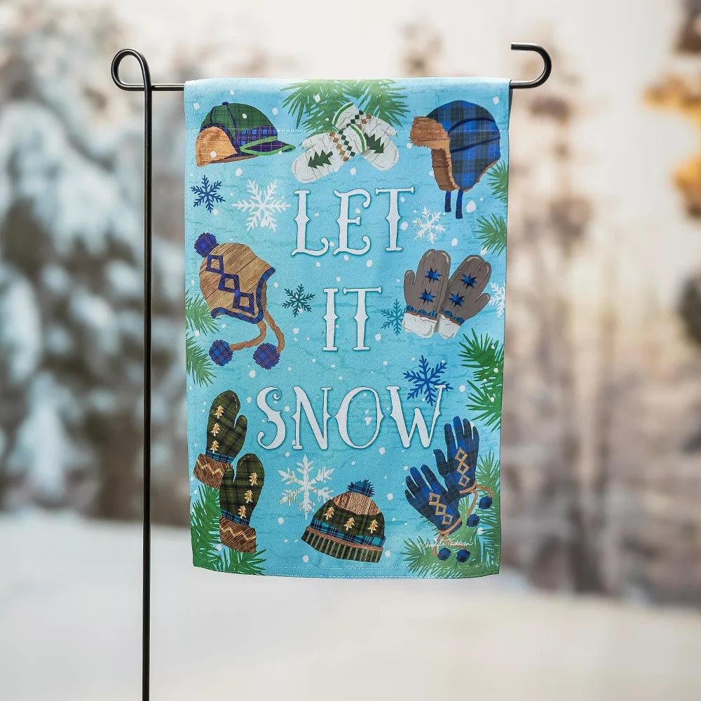 A light blue flag that reads "LET IT SNOW." The flag features different colored winter hats and gloves. There are also snowflakes and pine needles.