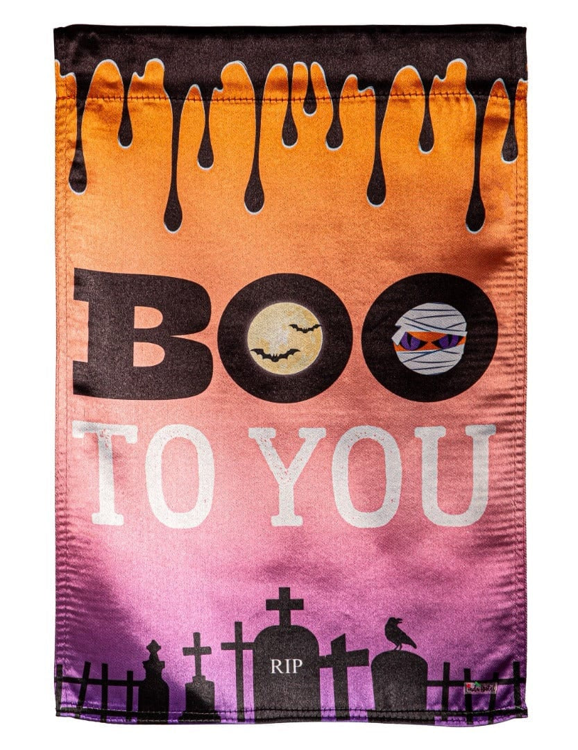 Halloween flag that reads "BOO TO YOU." The background goes from orange to pink to purple. At the top, it's designed to look like a black liquid is dripping from it. At the bottom, there's a black cemetery silhouette.