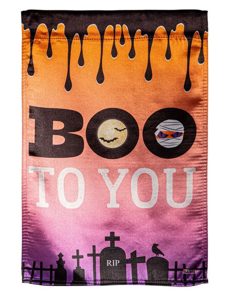 Halloween flag that reads "BOO TO YOU." The background goes from orange to pink to purple. At the top, it's designed to look like a black liquid is dripping from it. At the bottom, there's a black cemetery silhouette.