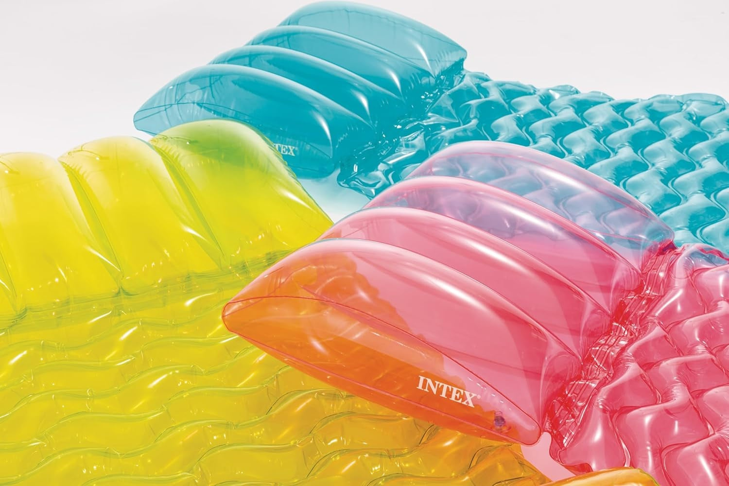 Transparent floating pool mattress. There are three different color options: lime green, pink or aqua blue.  This is an up close view of the built-in pillows on the mattresses.