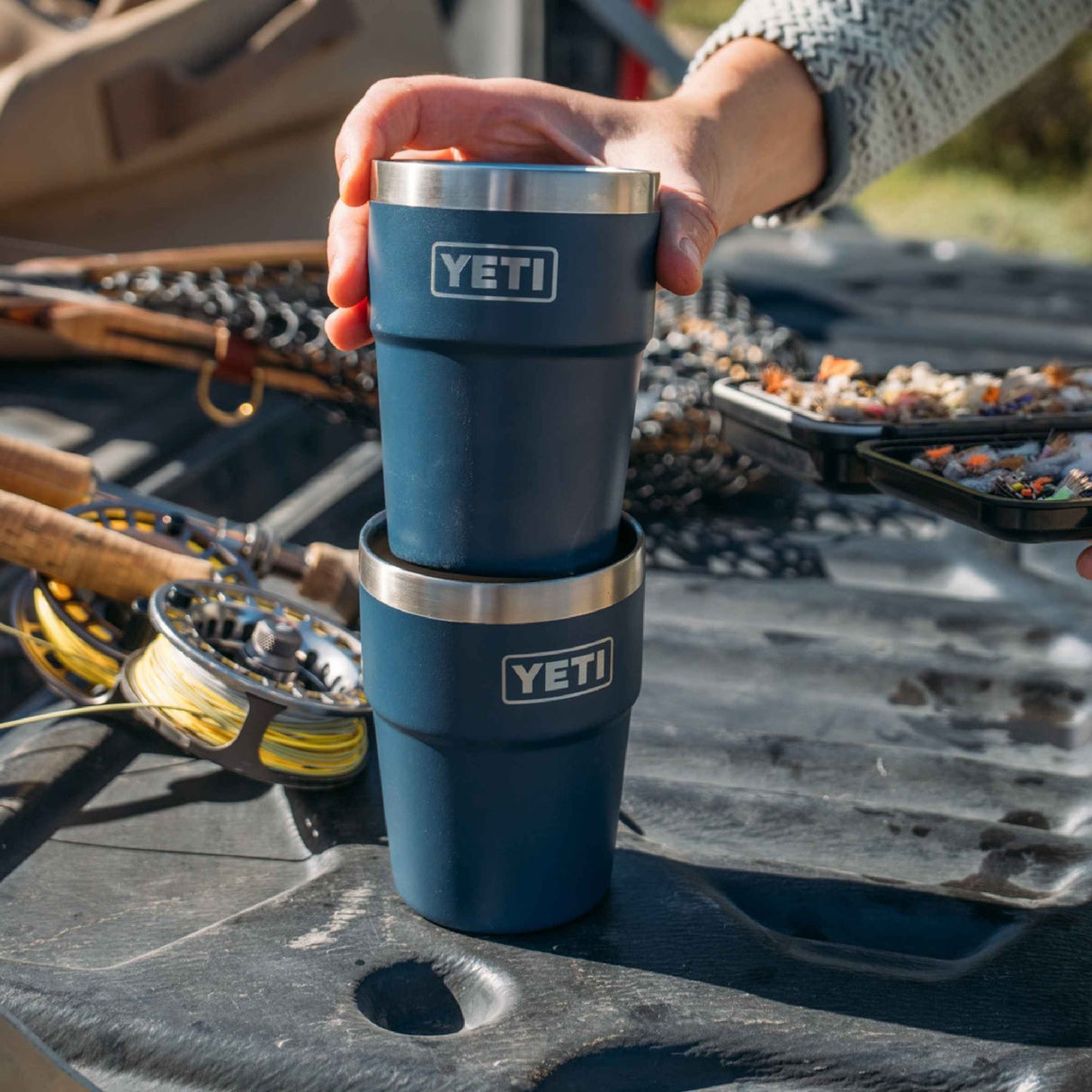 This lifestyle image shows the stackable design of this Yeti Rambler cup. This is the teal color.