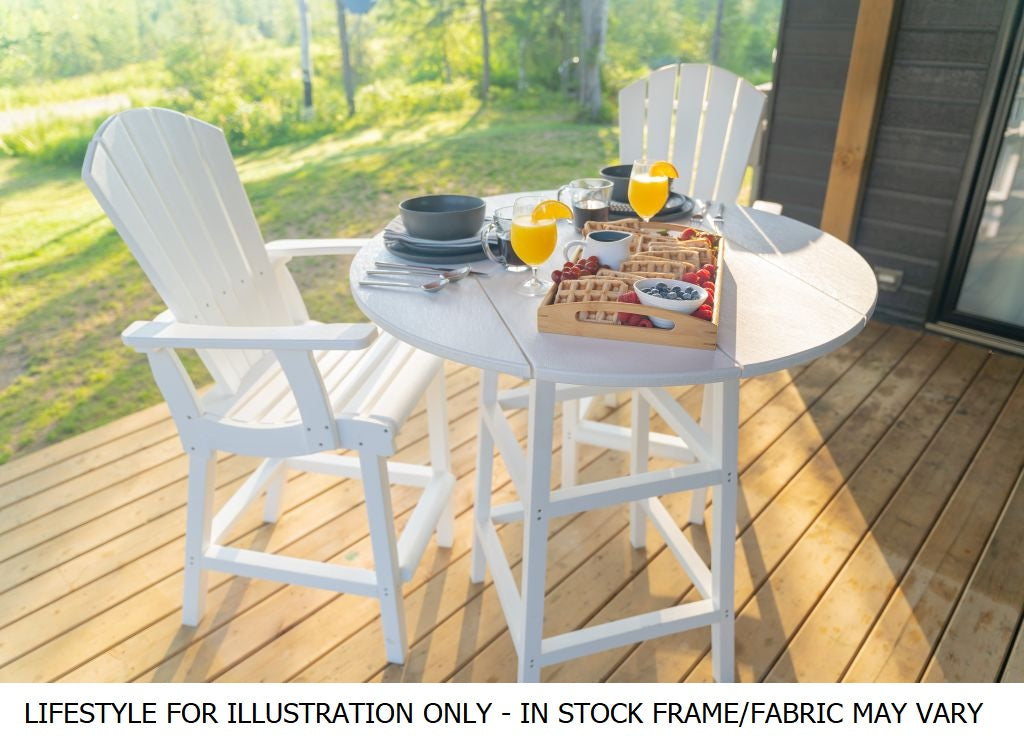 A counter height pub table with two armchairs on a porch in a grassy backyard