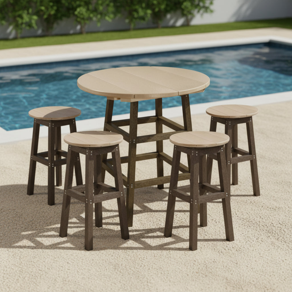 This is a lifestyle image showing this bar height table surrounded by four stools on a cement patio next to a swimming pool.