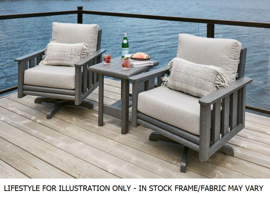 Two resin swivel chairs with an end table on a balcony over a body of water