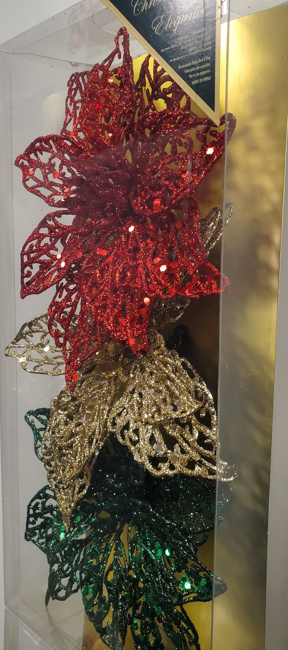 Clip on ornaments. One set of three features all red poinsettias. One set of three feature two red poinsettias and one green poinsettia. One set of three features two red poinsettias and one gold poinsettia. One set of three features one red, one gold and one green poinsettia.