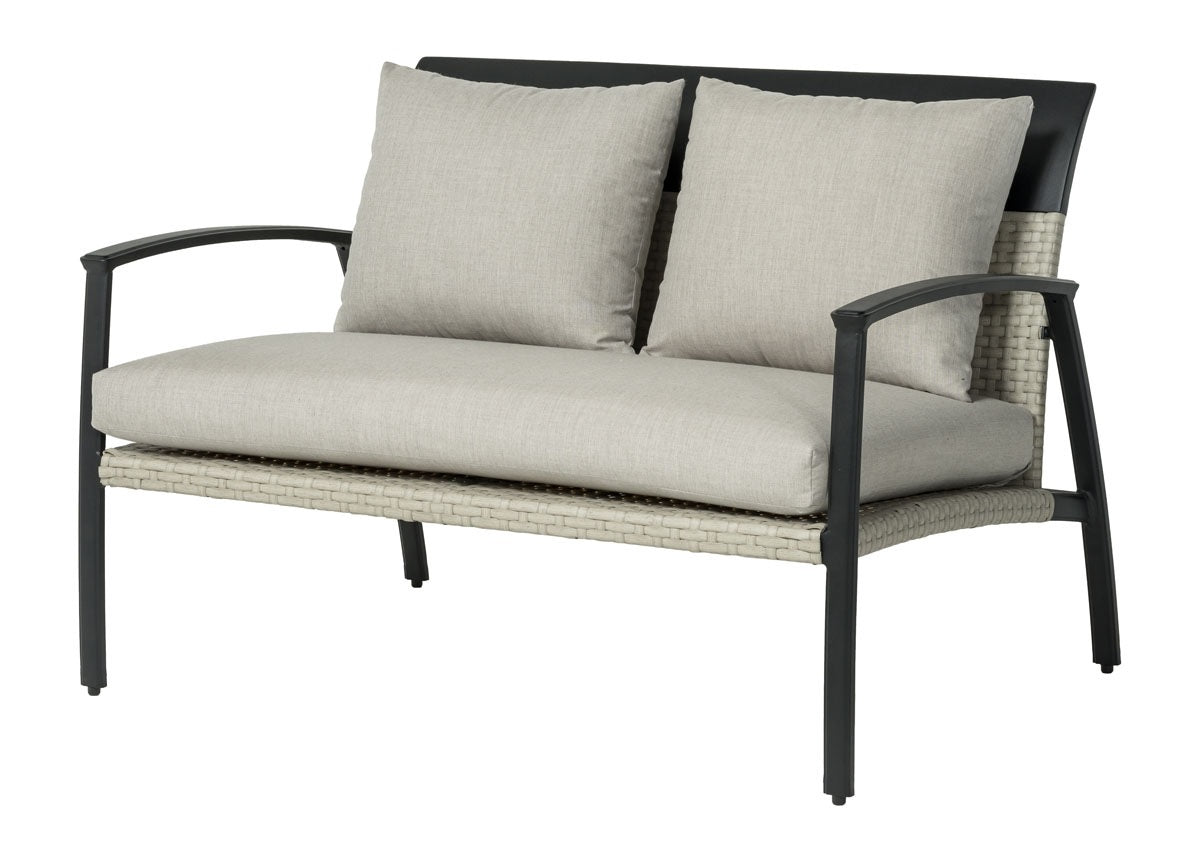 A loveseat made up of aluminum and wicker with removable cushions