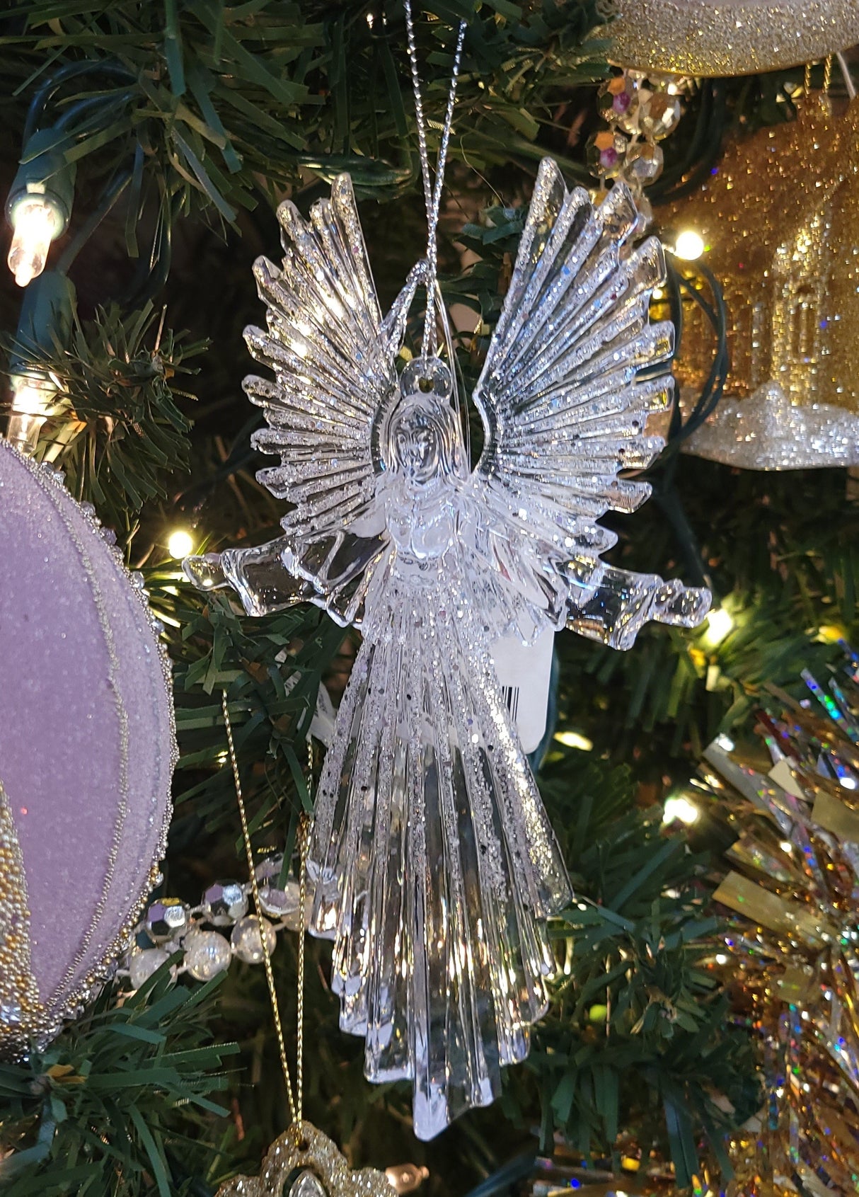 Glittered plastic ornaments shaped like an angel.