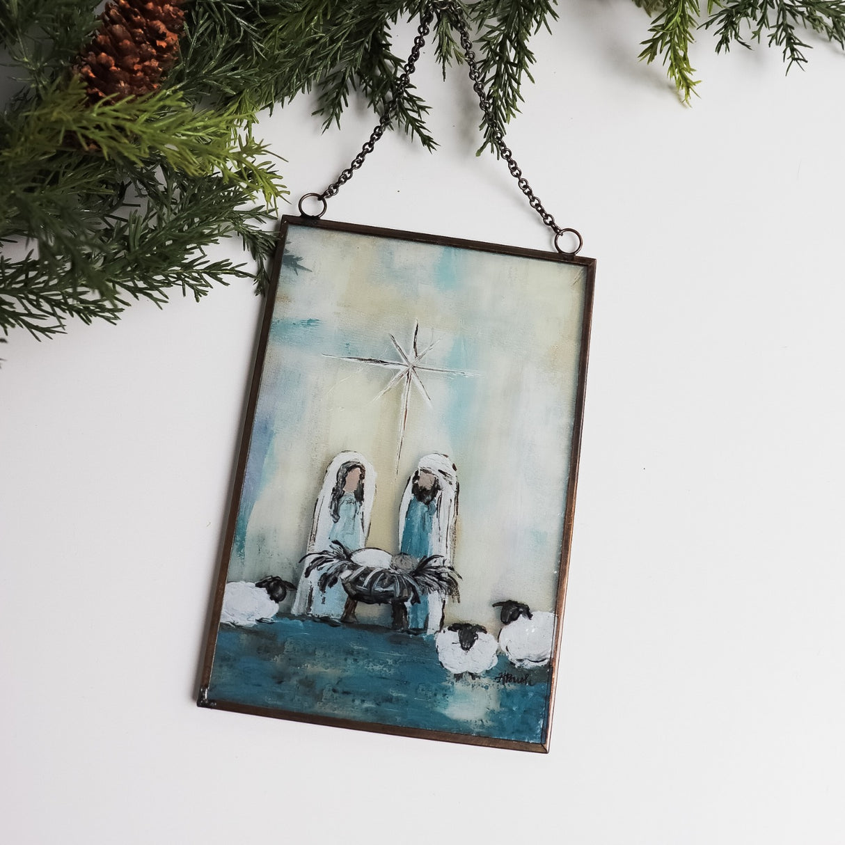 Christmas ornament with a painted Nativity Scene on it. Designed to look like stained glass.